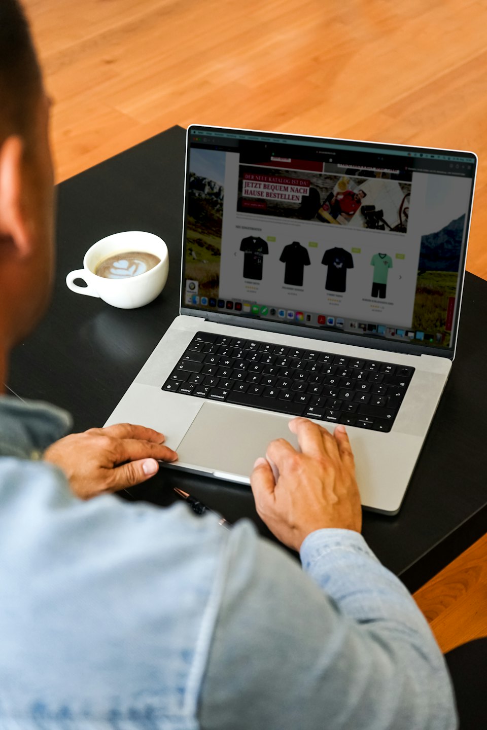 Person shopping for clothes online on a laptop.
