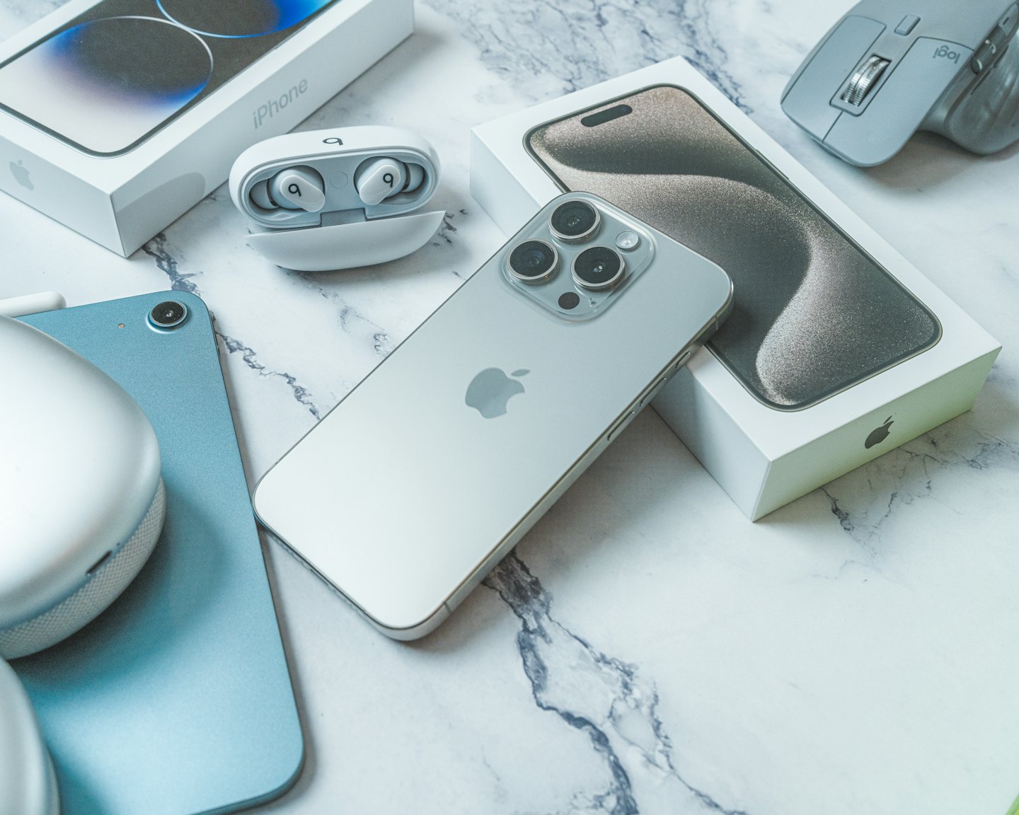 Modern tech gadgets arranged neatly on a marble surface.