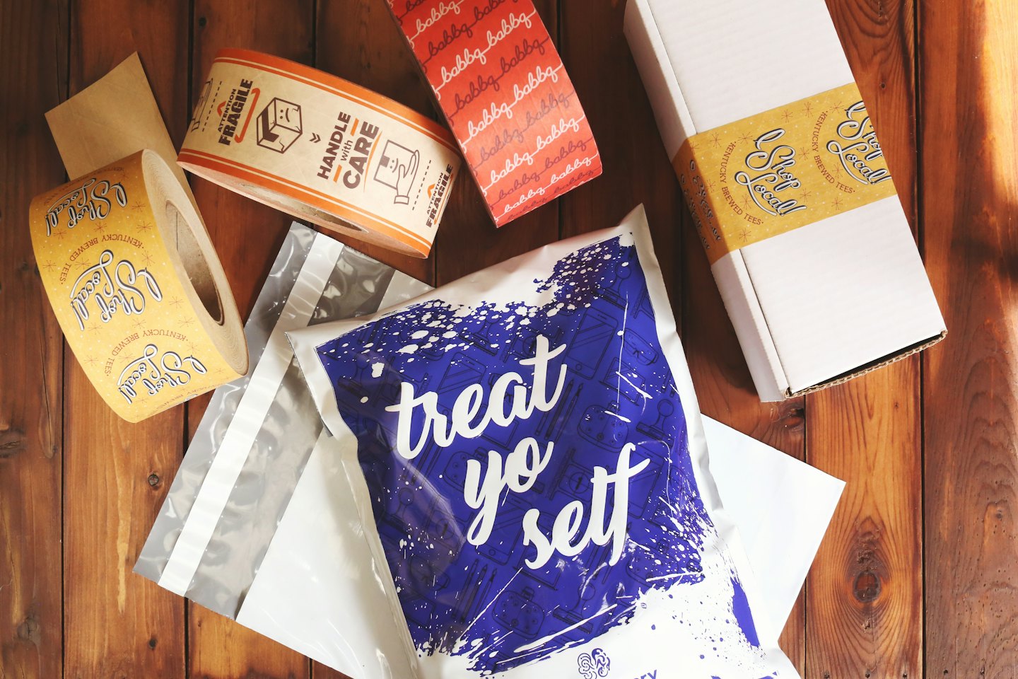 Packaging supplies for small businesses on a wooden table.