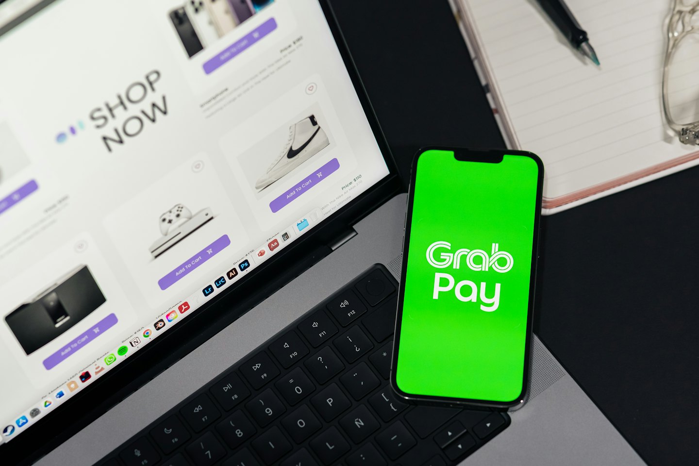 Laptop displaying an e-commerce site next to a smartphone showing a payment app.