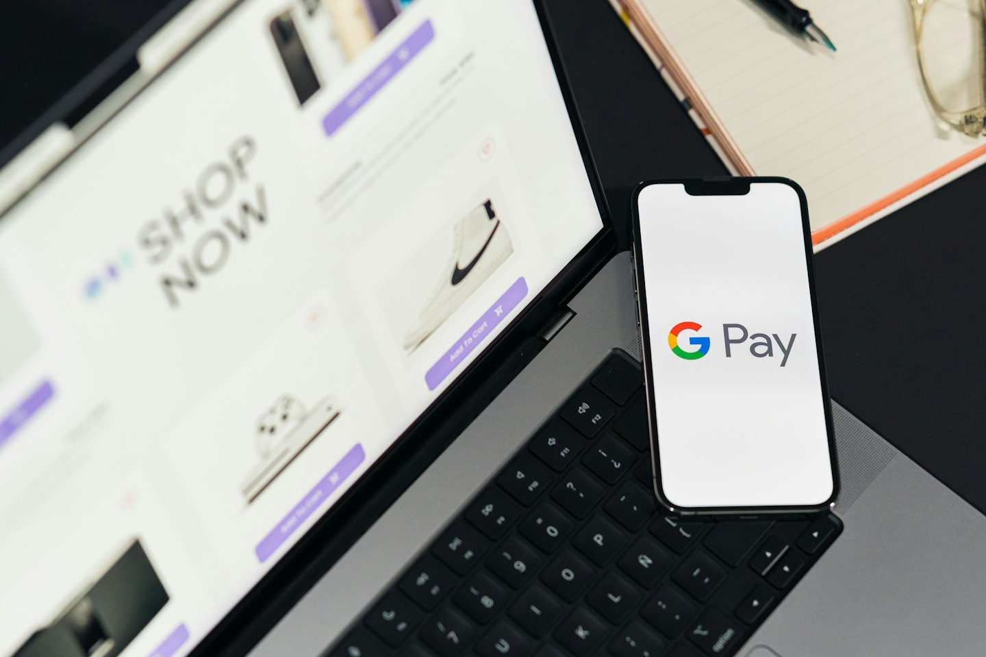 Smartphone displaying a digital payment app resting on a laptop.